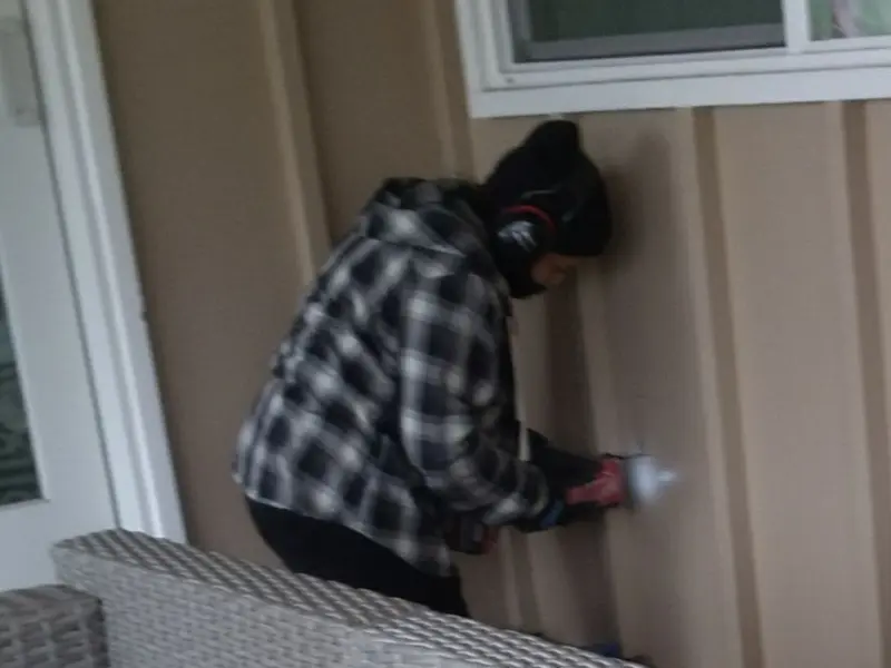 Professional electrician installing an exterior outlet in Minden